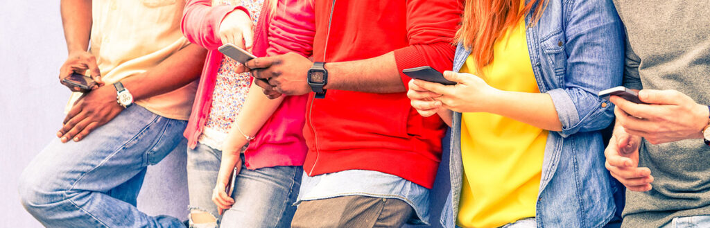 millennials looking at mobile phones