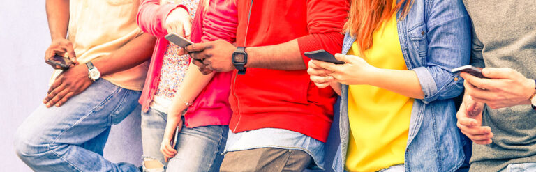 millennials looking at mobile phones