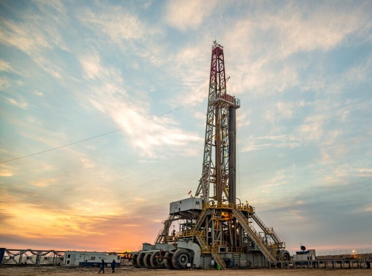 Large drilling machine with a sunset in the background.