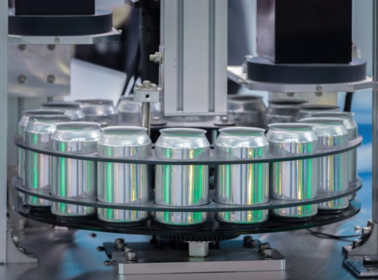A shot of an industrial plant with beverage cans being processed.