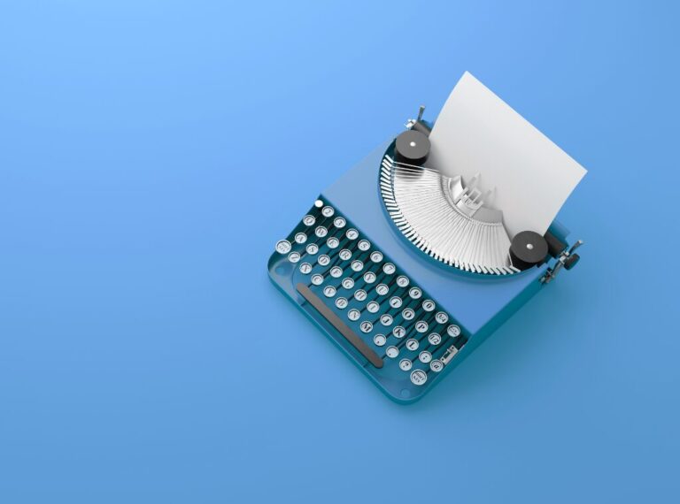 A blue, old-fashioned typewriter sits on a blue background.