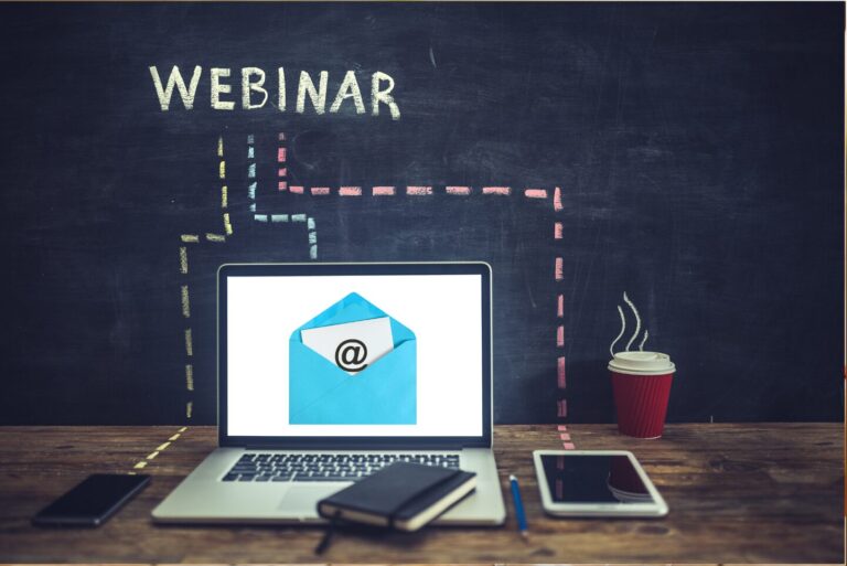 The word Webinar is written on a blackboard with lines drawn to a cellphone, computer and tablet.