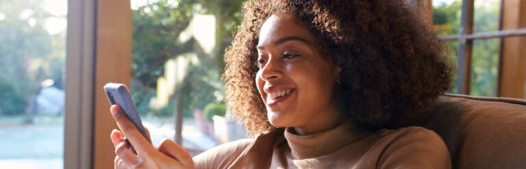 woman smiling at social media on phone