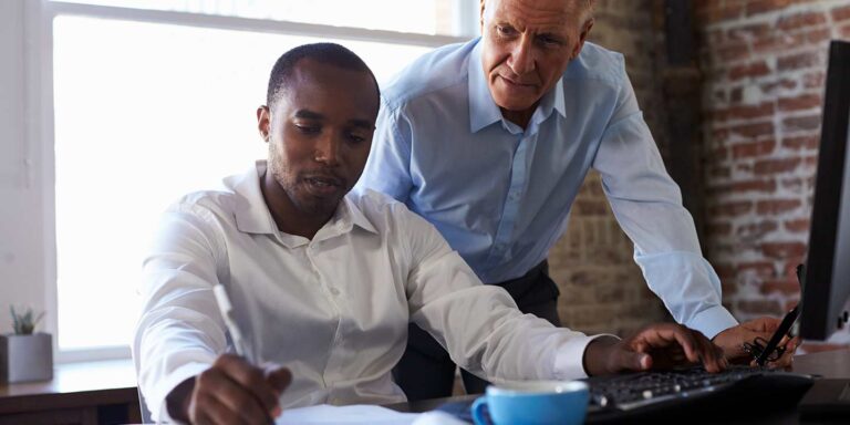 Businessmen reviewing website analytics for conversion rate