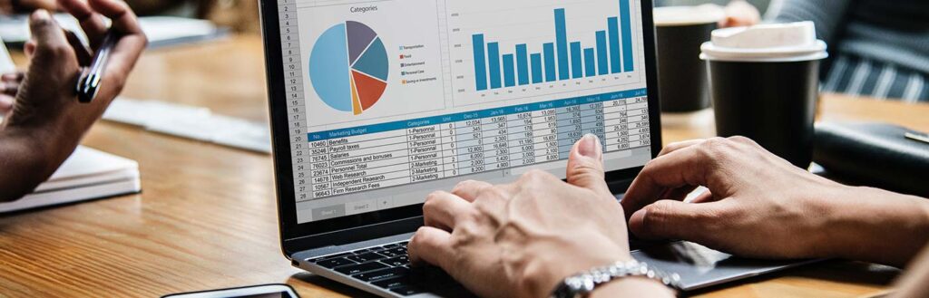 person typing on a laptop with website metrics on screen