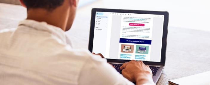 digital marketer reviewing email results on laptop