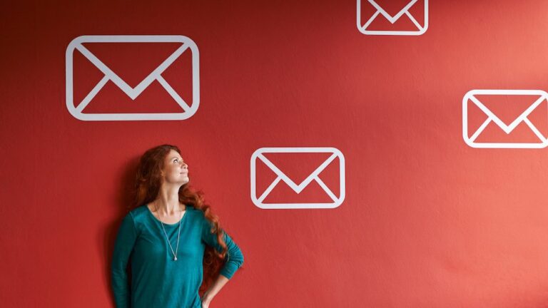 email marketing concept with lady looking at envelopes on a wall