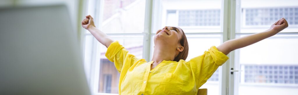 excited businesswoman writing content on laptop