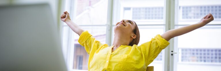 excited businesswoman writing content on laptop