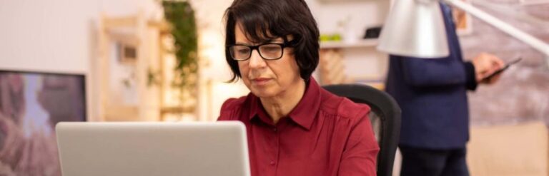 elderly woman using accessible website on laptop