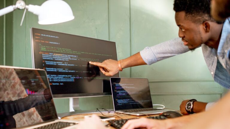 web developers reviewing code on a computer
