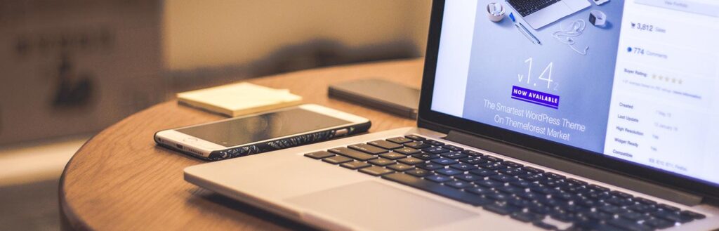 desk with laptop looking at wordpress theme