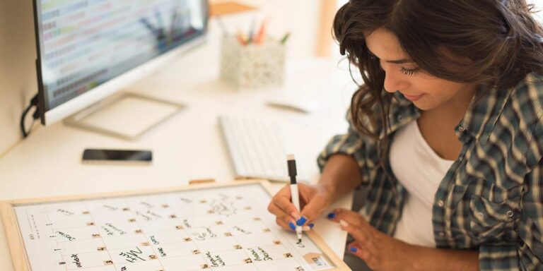 Woman planning out content on a calendar