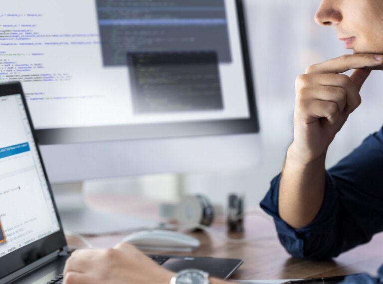 A businessman looking at a website on his laptop.